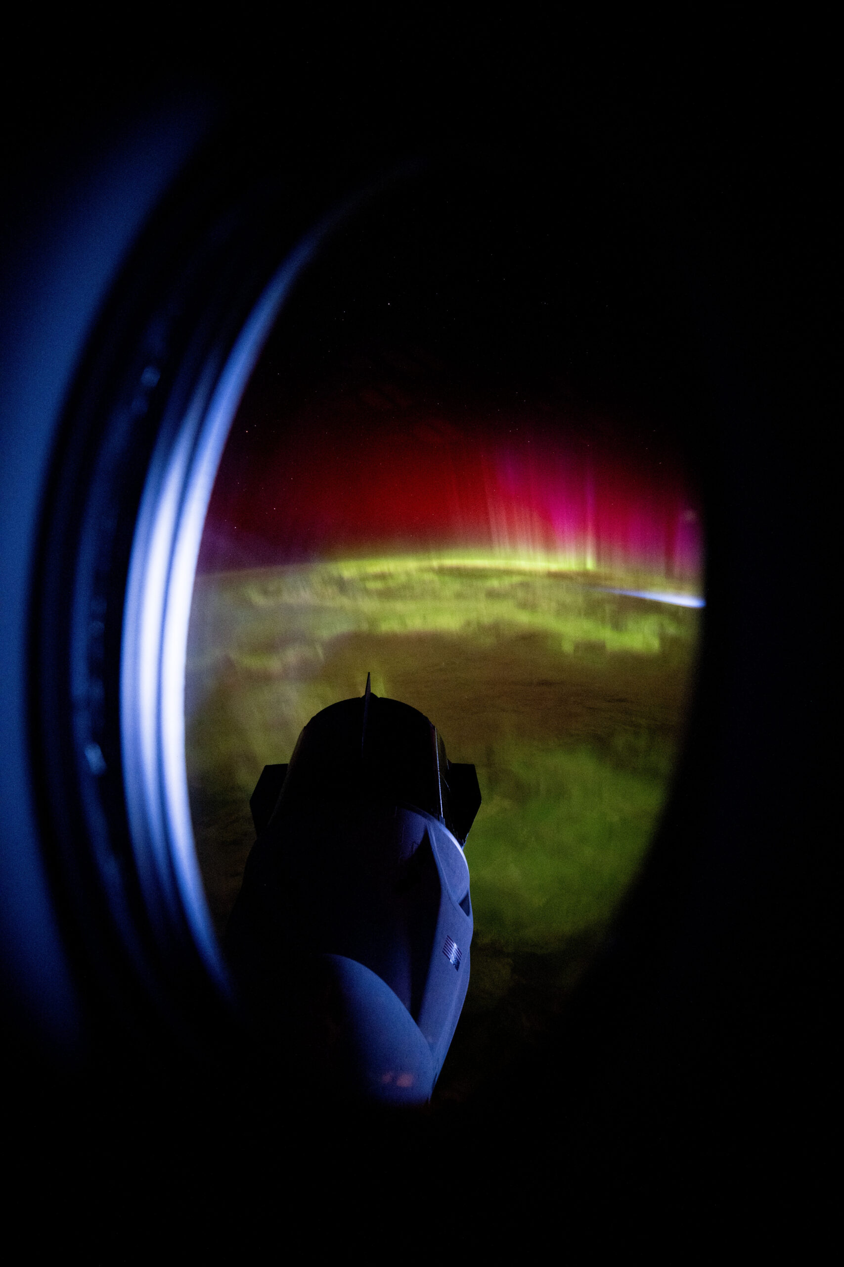 red and green aurora move through earth’s atmosphere