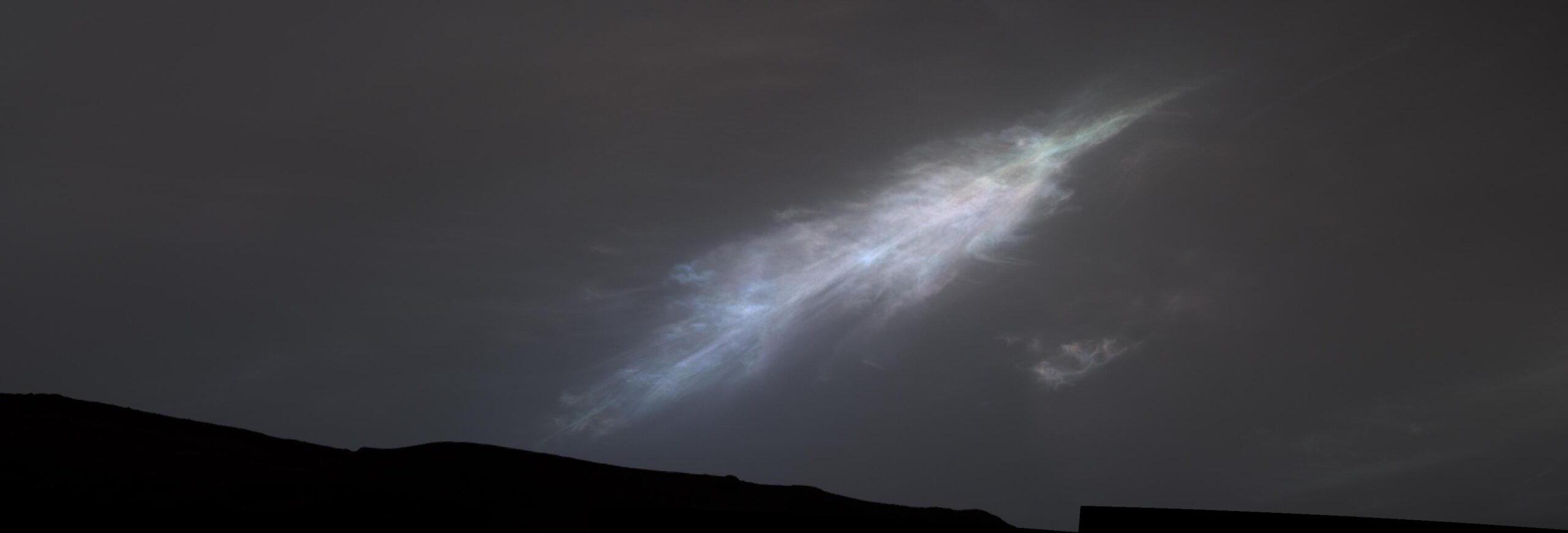 a rainbow colored “feather” in the martian sky