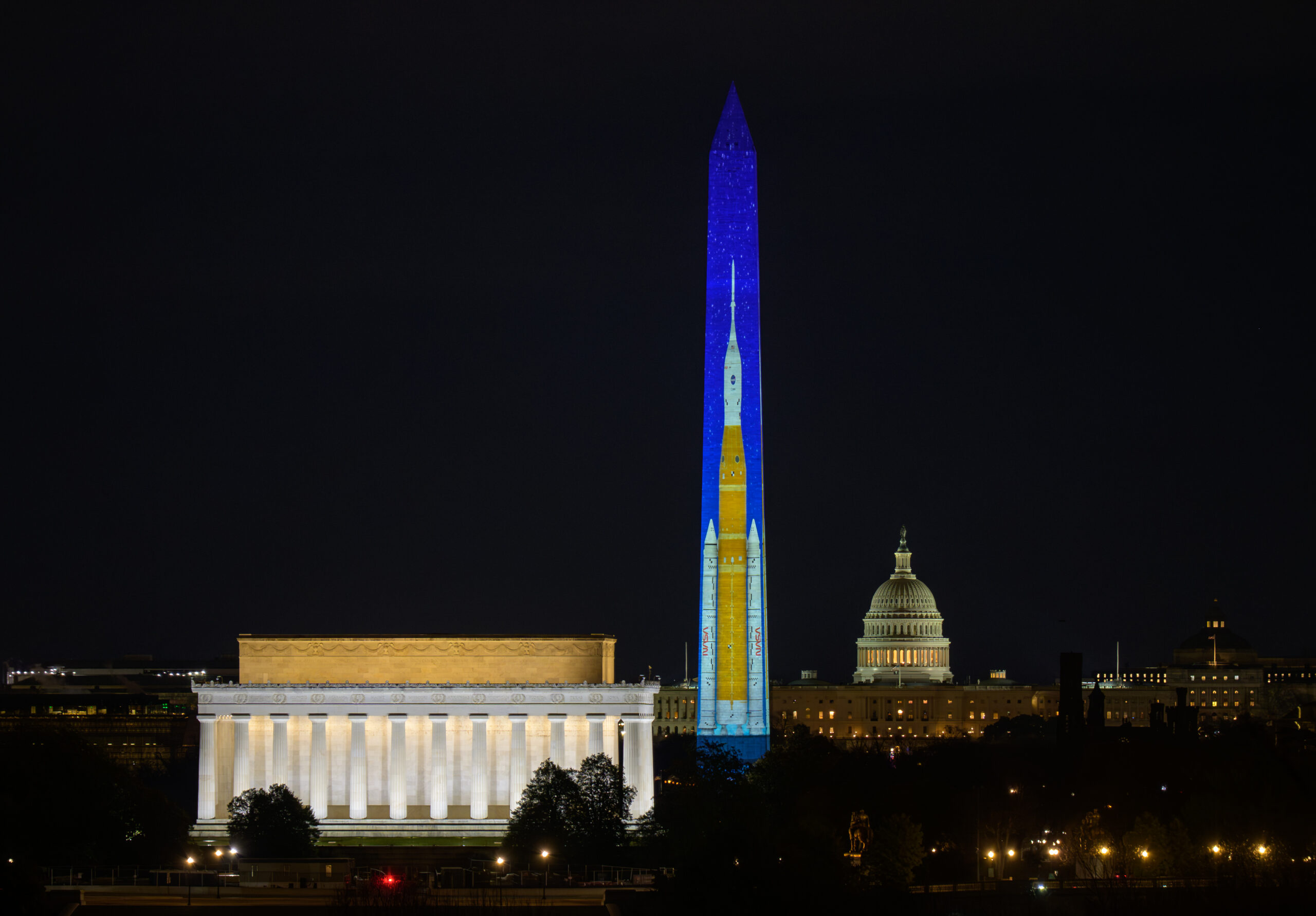 best of 2025: artemis ii sls (space launch system) projected on washington monument